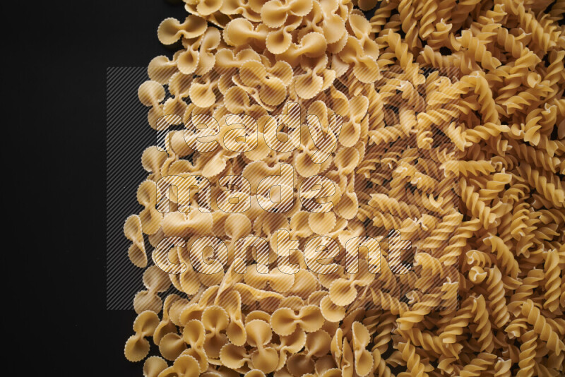Different pasta types on black background