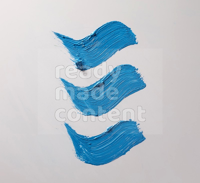 Multi blue curved brush strokes shaped into different shapes on a white background