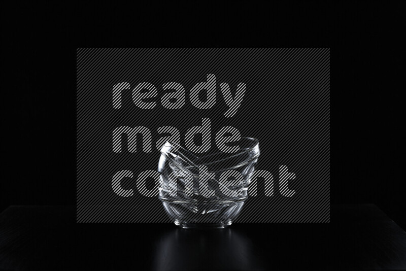 Glassware with rim light against black background