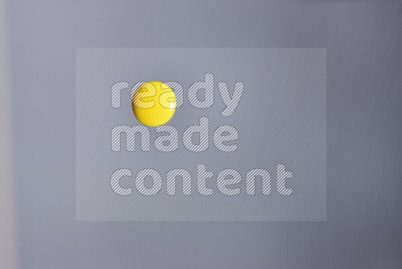 لقطات مقربة لقطرات من اللون الأصفر على خلفية رمادية