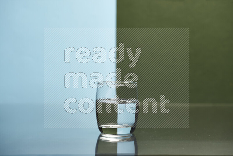 The image features a clear glassware filled with water, set against light blue and dark green background