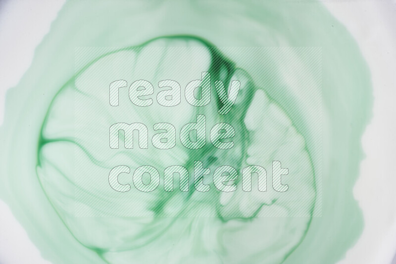 A close-up of abstract swirling patterns in green gradients