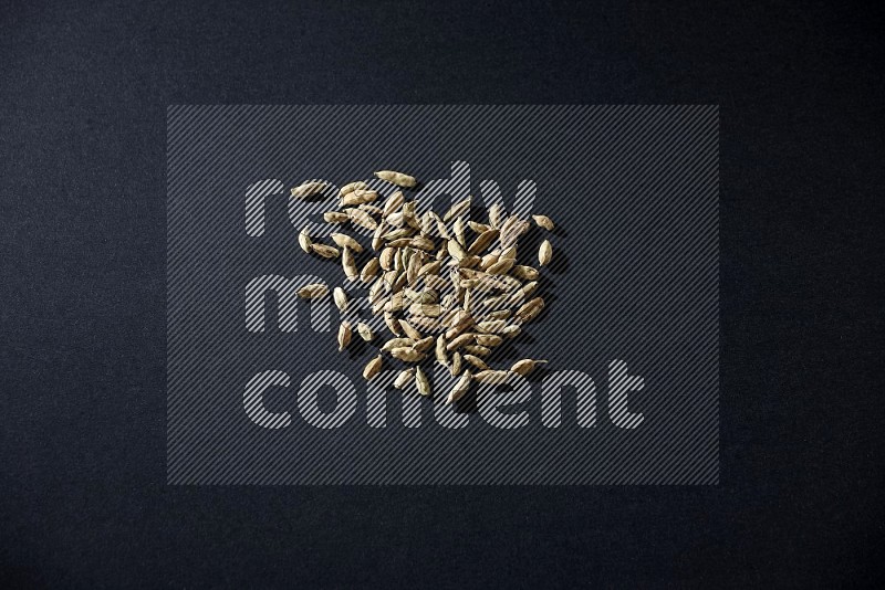 Cardamom seeds on black flooring