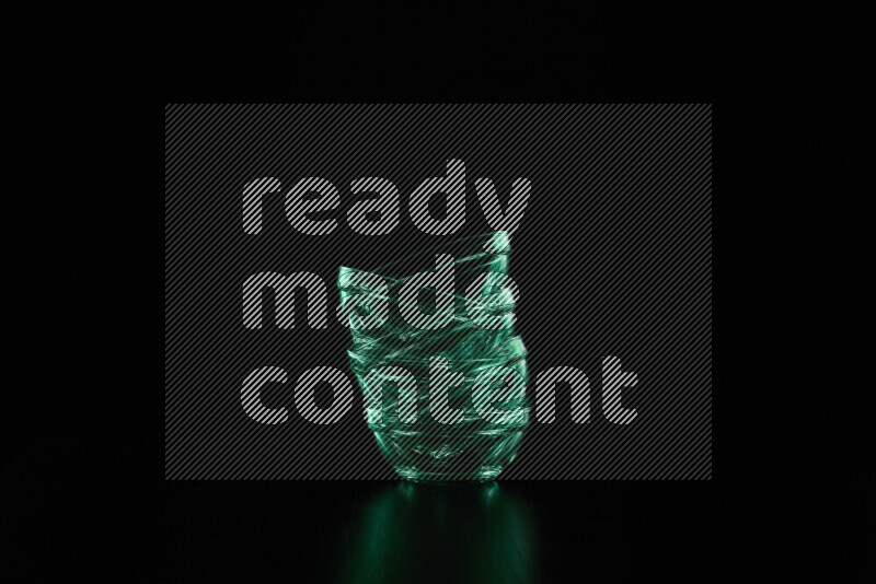 Glassware with rim light in green against black background