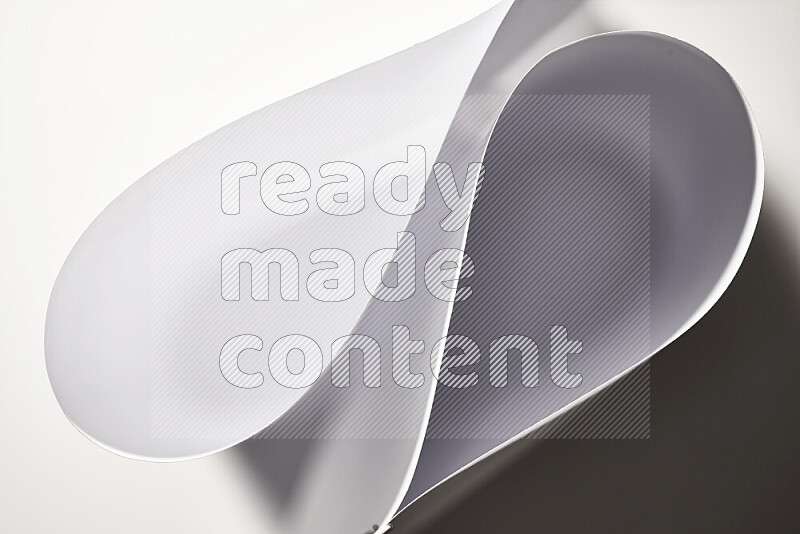 An abstract art of paper folded into smooth curves in grey gradients