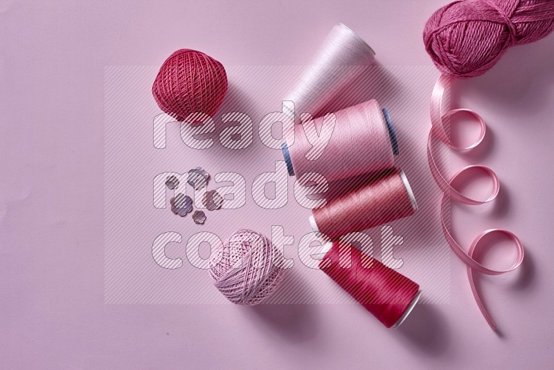 Pink sewing supplies on pink background