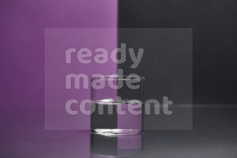 The image features a clear glassware filled with water, set against purple and black background