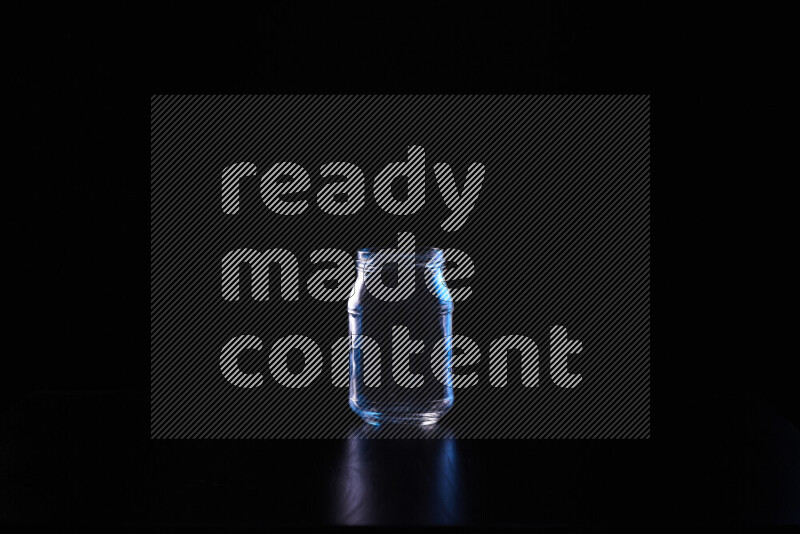 Glassware with rim light in blue and white against black background