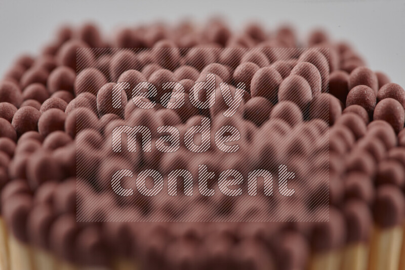 A close-up of a bundle of matches on grey background