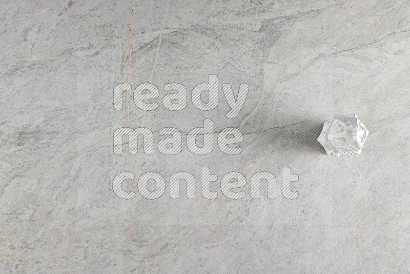 Top View Shot Of A Candle Lantern On Grey Marble Flooring