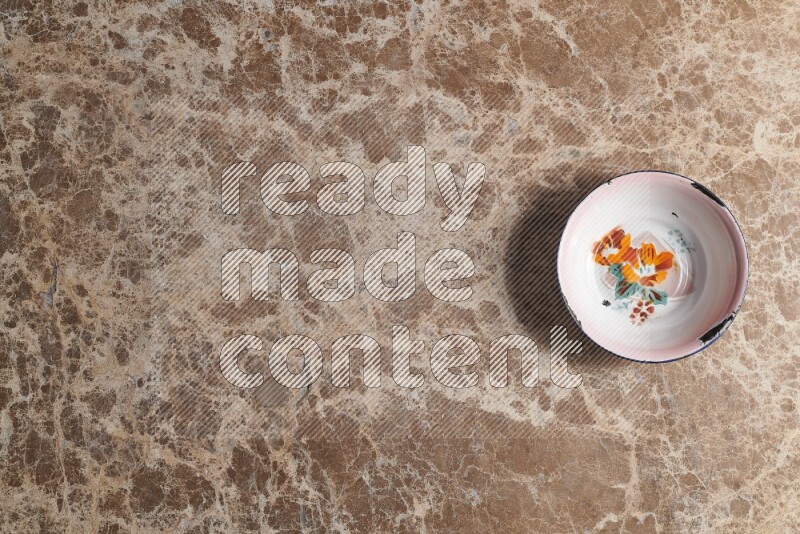 A vintage metal plate on beige marble background