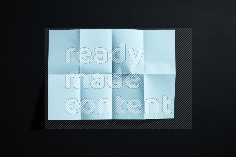 Blue paper sheet on black background