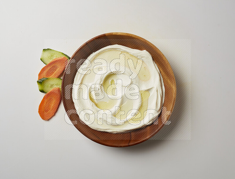 Lebnah garnished with olive oil in a wooden plate on a white background