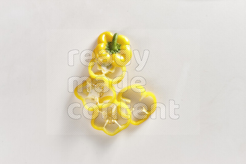 Yellow bell pepper slices on white background