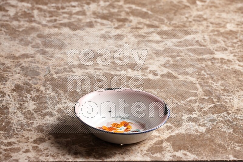 A vintage metal plate on beige marble background