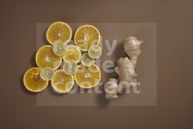 Fresh ginger root with different ingredients such as lemon, orange, honey, ground ginger on beige baackground