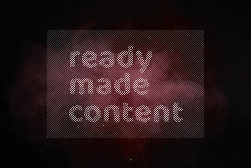 Red powder explosion on black background