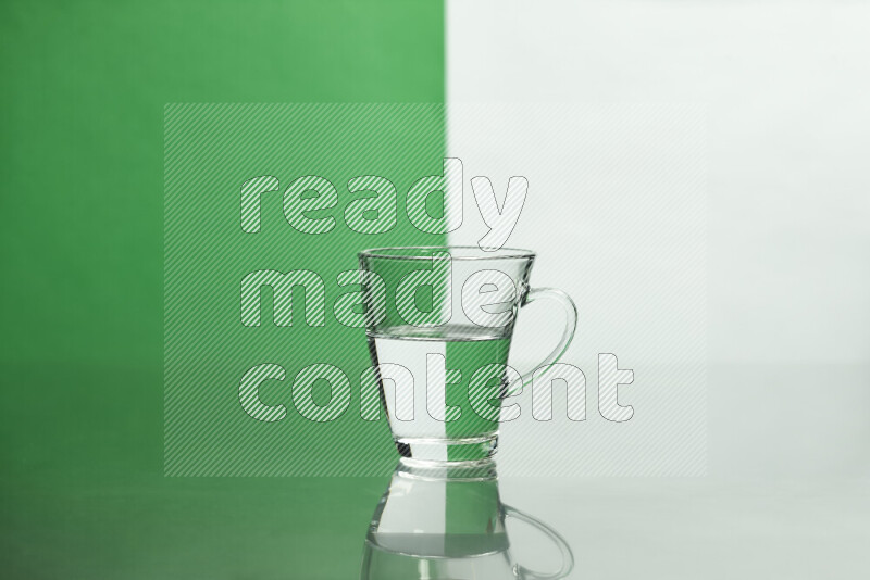 The image features a clear glassware filled with water, set against white and green background