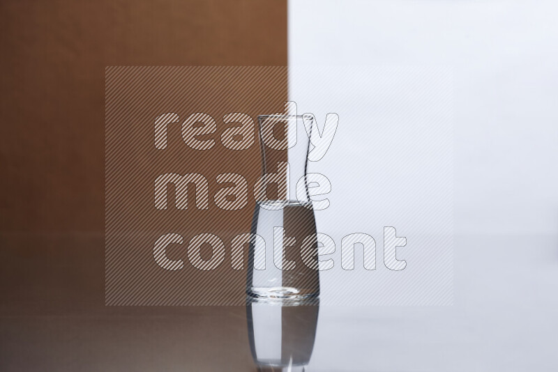 The image features a clear glassware filled with water, set against white and brown background