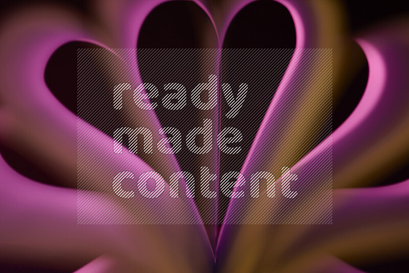 An abstract art piece displaying smooth curves in yellow and pink gradients created by colored light