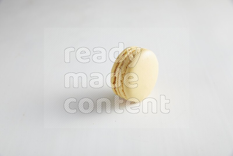 45º Shot of Yellow Vanilla macaron on white background