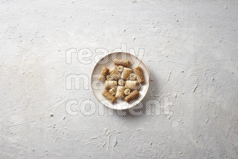 Oriental sweets in pottery plates in a light setup