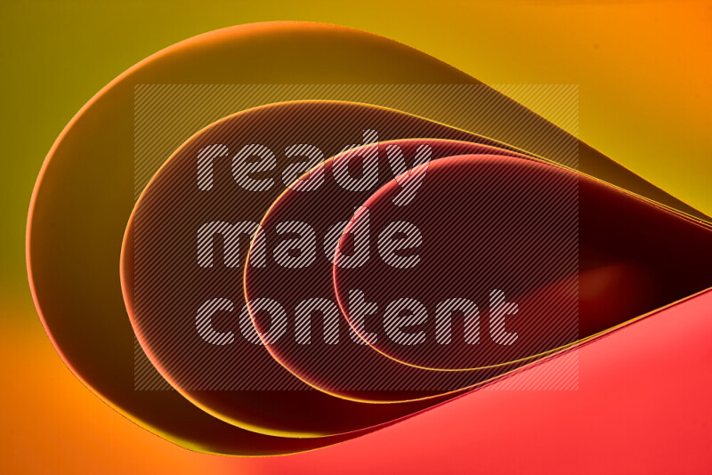 An abstract art of paper folded into smooth curves in yellow, brown and red gradients