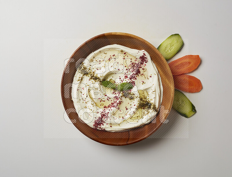 Lebnah garnished with  zattar , sumak & mint in a wooden plate on a white background