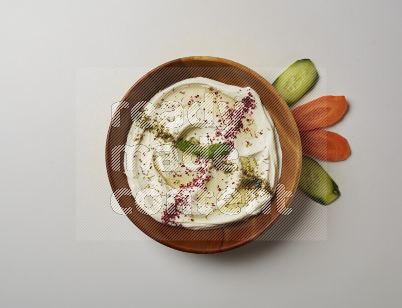 Lebnah garnished with  zattar , sumak & mint in a wooden plate on a white background