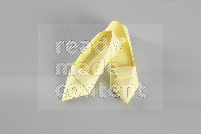 Origami shoes on grey background