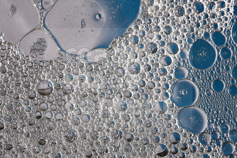 Close-ups of abstract soap bubbles and water droplets on blue background