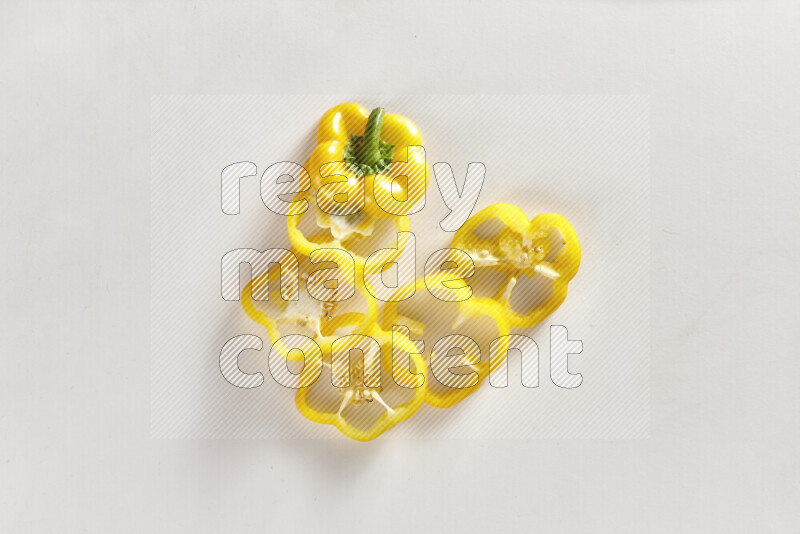 Yellow bell pepper slices on white background