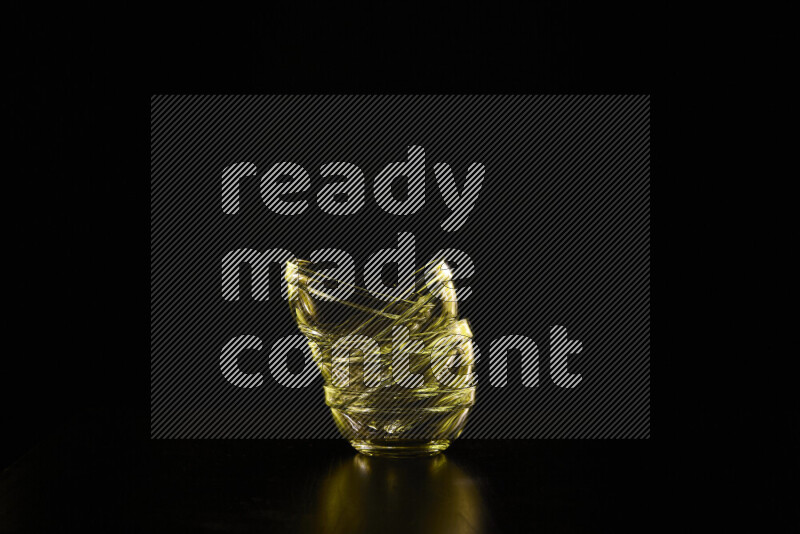 Glassware with rim light in yellow against black background