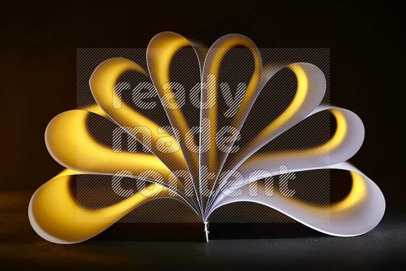 An abstract art piece displaying smooth curves in yellow and white gradients created by colored light