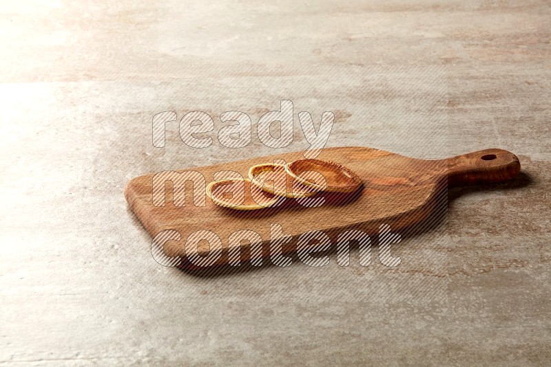 Three stacked plain mini pancakes on a wooden board on beige background