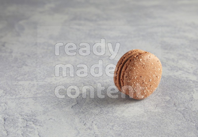 45º Shot of Brown Hazelnuts macaron on white  marble background