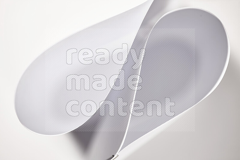 An abstract art of paper folded into smooth curves in grey gradients