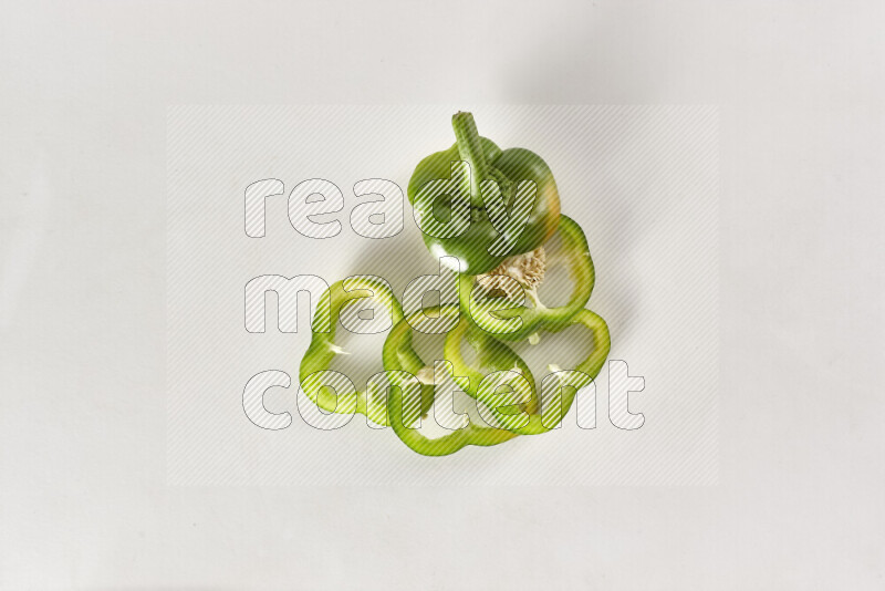 Green bell pepper slices on white background