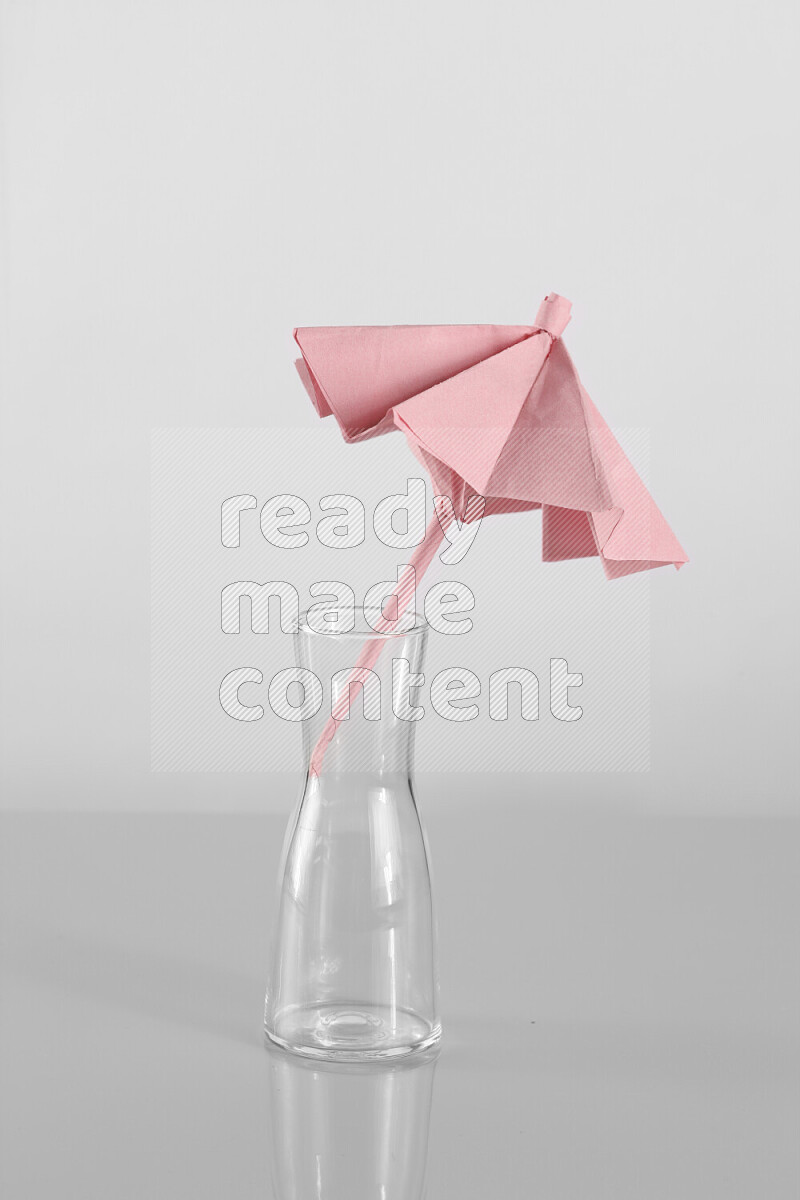 Origami umbrella on grey background