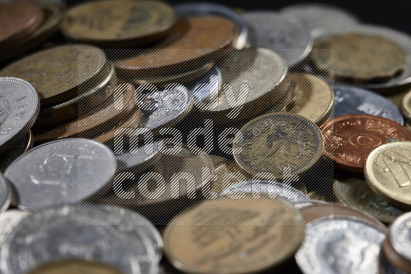 A close-ups of random old coins on black background