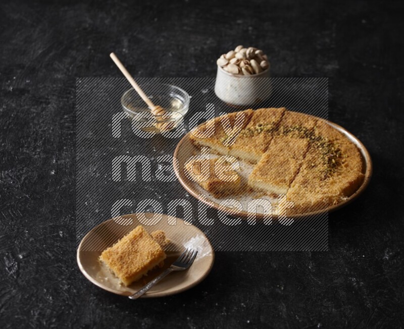 Konafa with nuts and honey in a dark setup