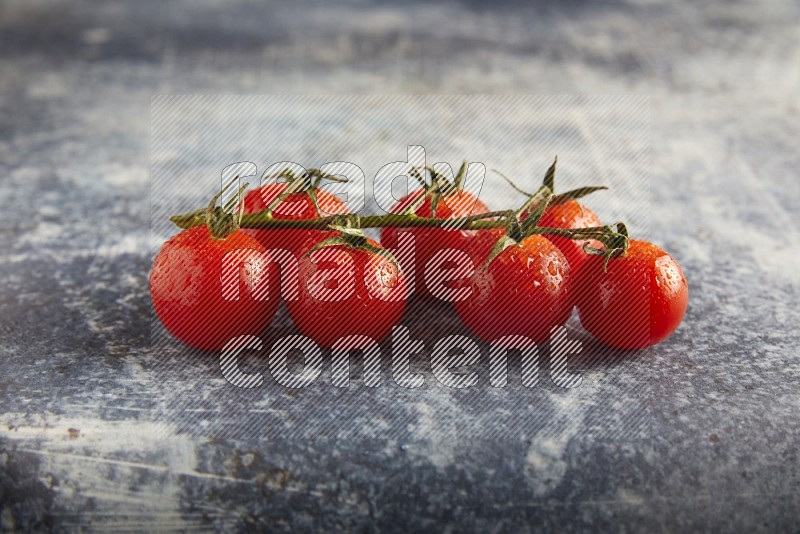 Red cherry tomato vein on a textured rusty blue background 45 degree