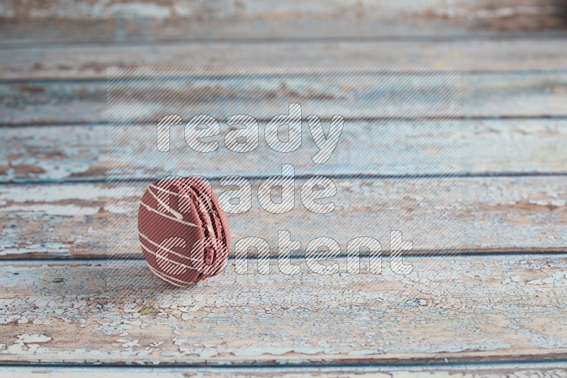 45º Shot of Red Poppy Flower macaron on light blue wooden background