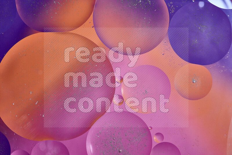 Close-ups of abstract oil bubbles on water surface in shades of purple, orange and pink