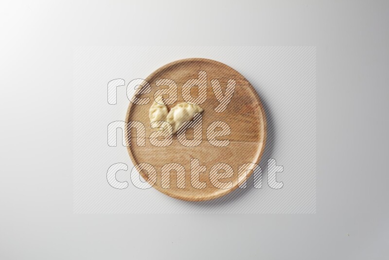 Two Sambosas on a wooden round plate on a white background