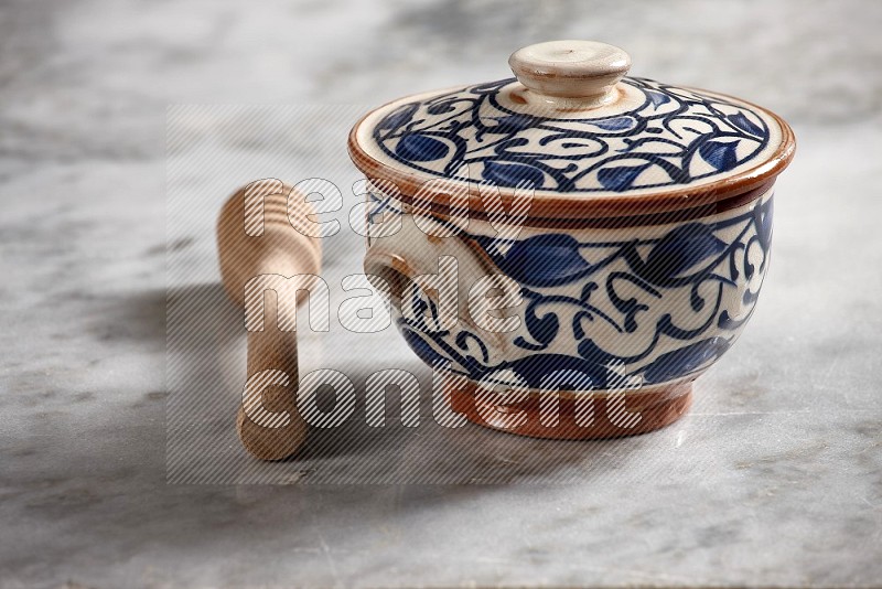Decorative Pottery pot with wooden honey handle on the side with grey marble flooring, 15 degree angle