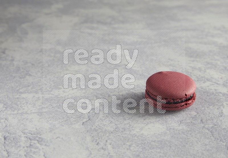 45º Shot of Red Cherry macaron on white  marble background
