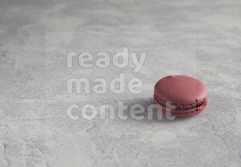 45º Shot of Red Cherry macaron on white  marble background