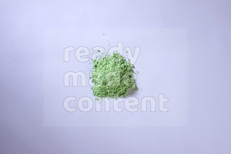 Green powder on white background