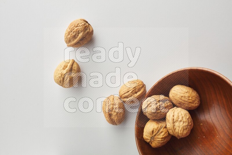 Top-view shot of walnut in a container on white background